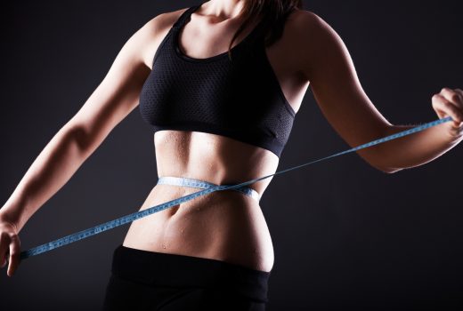 Fitness woman measuring her waist, weight loss